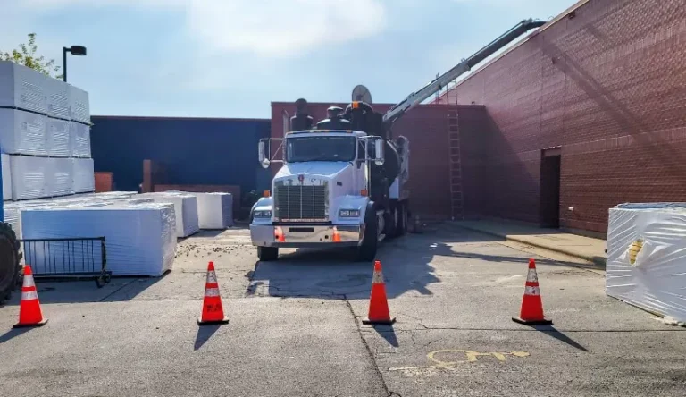 truck at job site with traffic cones in front